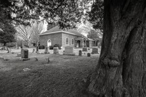 Header-bond church seen across the cemetery